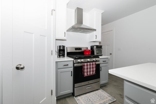 659 S Lakeside Dr, Franklin, ID 83237 - kitchen with wall chimney range hood, stainless steel gas range, light wood finished floors, light countertops, and gray cabinets