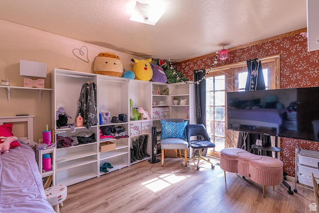570 N 400 W, Logan, UT 84321 - bedroom featuring wallpapered walls, wood finished floors, and a textured ceiling