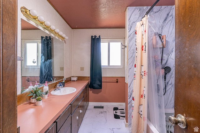 570 N 400 W, Logan, UT 84321 - full bath featuring marble look tile flooring, vanity, plenty of natural light, shower / bath combination with curtain, and a textured ceiling