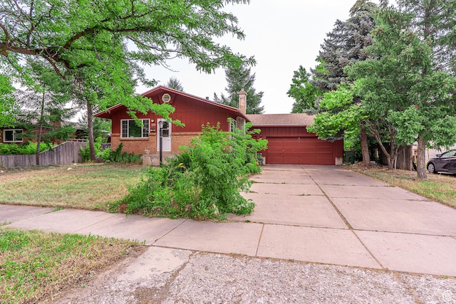 570 N 400 W, Logan, UT 84321 - view of front of property with a garage, concrete driveway, and brick siding