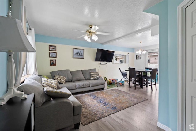 1124 S 1000 E Unit 3, Provo, UT 84606 - living room with wood finished floors, a textured ceiling, ceiling fan, and a chandelier