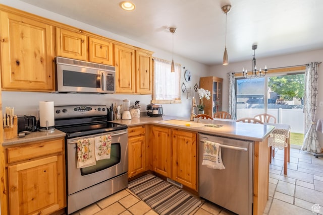 4091 W Juniper Hills Dr, South Jordan, UT 84095 - kitchen with appliances with stainless steel finishes, light countertops, a chandelier, a peninsula, and hanging light fixtures