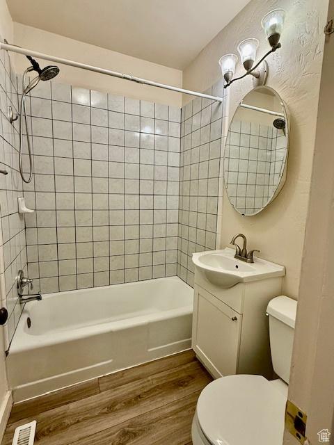 624 N 500 W, Vernal, UT 84078 - bathroom featuring wood finished floors, vanity, and shower / tub combination