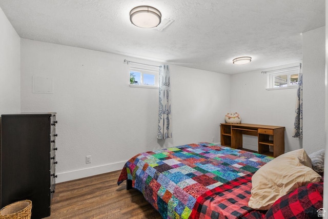 784 Lavina Dr, South Ogden, UT 84403 - bedroom with wood finished floors, multiple windows, and a textured ceiling