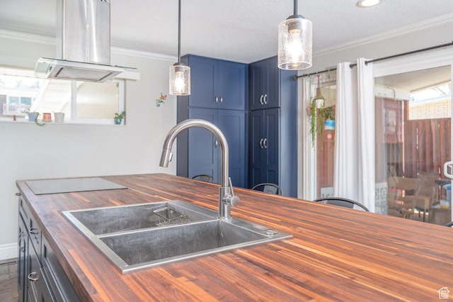 784 Lavina Dr, South Ogden, UT 84403 - kitchen featuring wooden counters, blue cabinetry, ornamental molding, decorative light fixtures, and island range hood