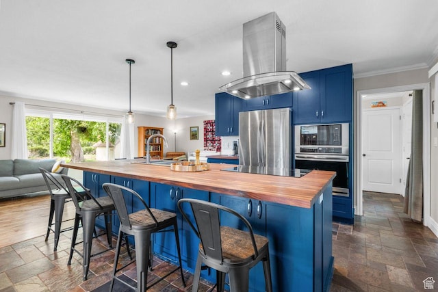 784 Lavina Dr, South Ogden, UT 84403 - kitchen featuring wood counters, island range hood, blue cabinetry, stainless steel appliances, and stone tile floors