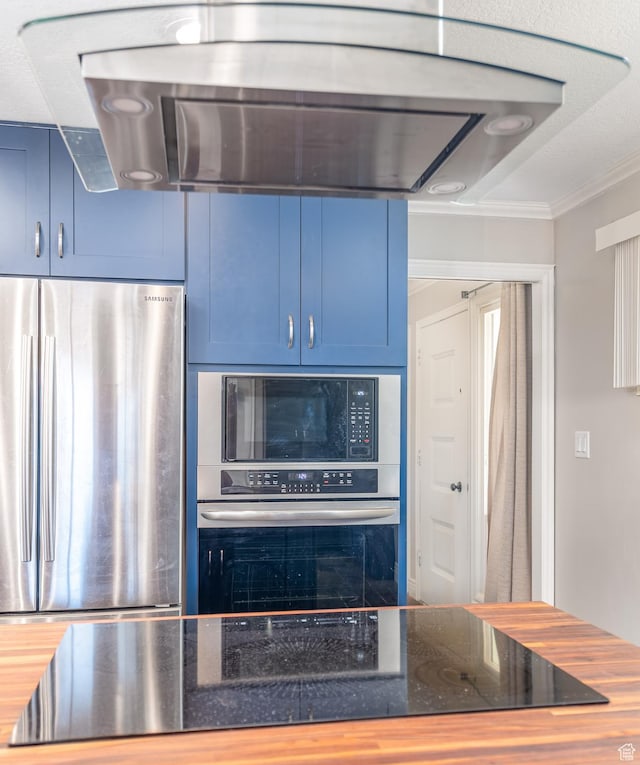 784 Lavina Dr, South Ogden, UT 84403 - kitchen with appliances with stainless steel finishes, range hood, blue cabinetry, ornamental molding, and dark stone counters