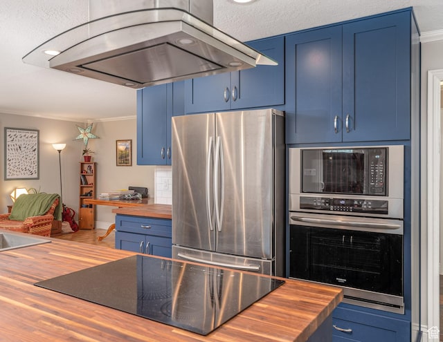 784 Lavina Dr, South Ogden, UT 84403 - kitchen with black appliances, wood counters, island exhaust hood, blue cabinetry, and crown molding