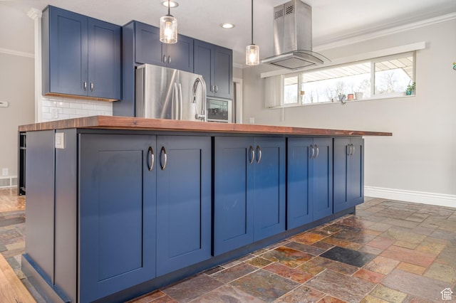 784 Lavina Dr, South Ogden, UT 84403 - kitchen featuring freestanding refrigerator, island exhaust hood, blue cabinetry, butcher block counters, and ornamental molding