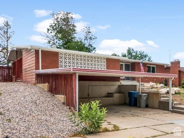 784 Lavina Dr, South Ogden, UT 84403 - back of property featuring brick siding and concrete driveway