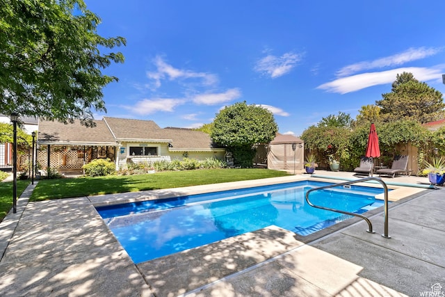 2484 W Gordon Ave, Layton, UT 84041 - view of swimming pool featuring a storage unit, a patio area, and a fenced backyard