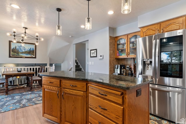 2484 W Gordon Ave, Layton, UT 84041 - kitchen featuring stainless steel fridge, brown cabinetry, and a textured ceiling