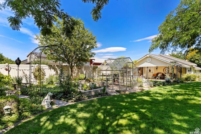 2484 W Gordon Ave, Layton, UT 84041 - fenced backyard with a greenhouse, an outbuilding, and a garden