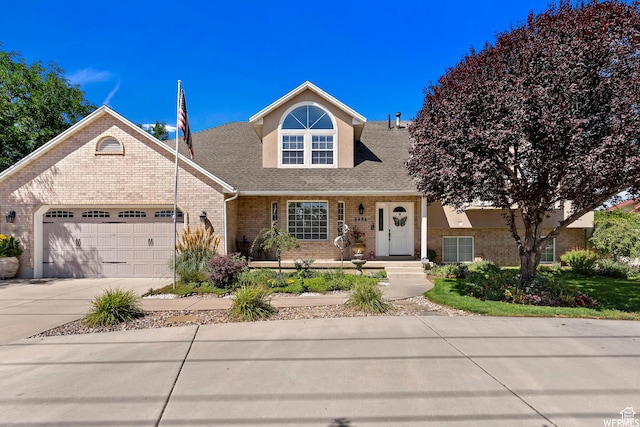 2484 W Gordon Ave, Layton, UT 84041 - traditional-style home with brick siding, an attached garage, concrete driveway, and roof with shingles