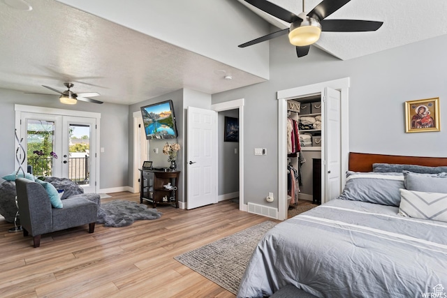 2484 W Gordon Ave, Layton, UT 84041 - bedroom with access to exterior, light wood finished floors, a textured ceiling, a walk in closet, and a ceiling fan