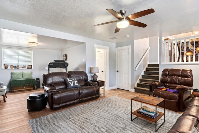 2484 W Gordon Ave, Layton, UT 84041 - living area featuring wood finished floors, a ceiling fan, a textured ceiling, and stairs