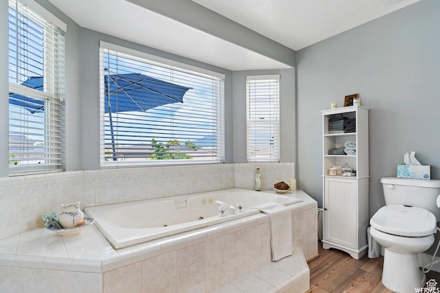 2484 W Gordon Ave, Layton, UT 84041 - bathroom with a tub with jets and wood finished floors