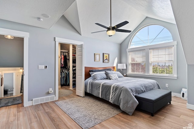 2484 W Gordon Ave, Layton, UT 84041 - bedroom featuring a walk in closet, light wood finished floors, a textured ceiling, a closet, and ceiling fan