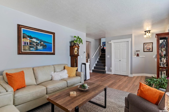 2484 W Gordon Ave, Layton, UT 84041 - living room featuring wood finished floors, stairway, and a textured ceiling