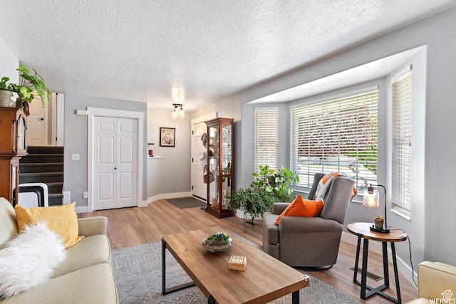 2484 W Gordon Ave, Layton, UT 84041 - living area featuring wood finished floors, a textured ceiling, and stairs
