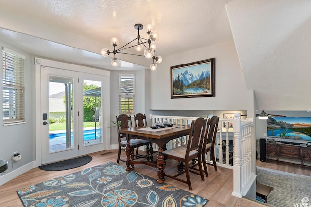2484 W Gordon Ave, Layton, UT 84041 - dining room featuring a chandelier, a textured ceiling, and wood finished floors