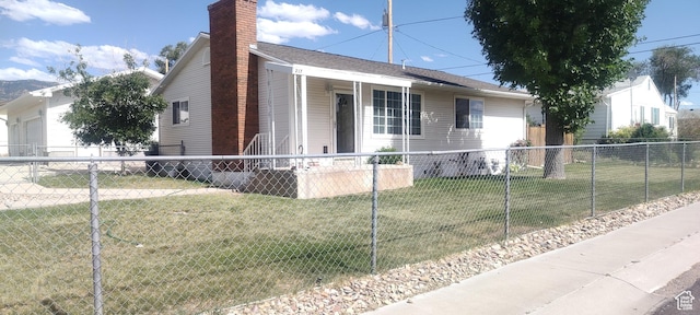 217 Wilkins, East Carbon, UT 84520 - view of front of home with a fenced front yard, a chimney, a garage, and covered porch