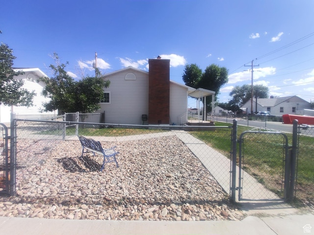 217 Wilkins, East Carbon, UT 84520 - view of property exterior featuring a gate and a chimney