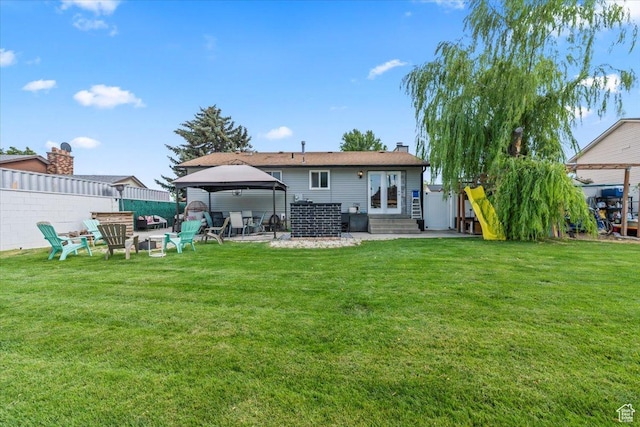 4334 W Tidwell St, Salt Lake City, UT 84118 - back of house featuring a gazebo, entry steps, a chimney, and a patio area
