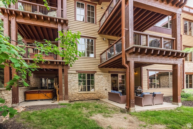 1825 Three Kings Dr Unit 3101, Park City, UT 84060 - rear view of property with a balcony, a hot tub, stone siding, and outdoor lounge area