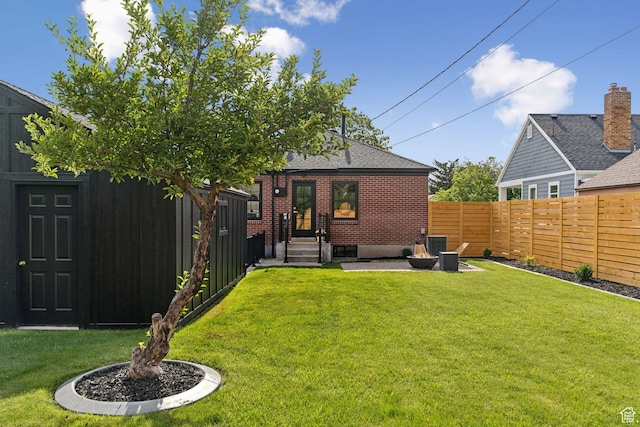 2487 S Beverly St E, Salt Lake City, UT 84106 - rear view of property with a fenced backyard, brick siding, and roof with shingles