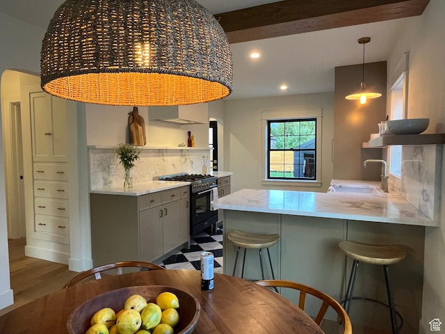 2487 S Beverly St E, Salt Lake City, UT 84106 - kitchen with gas range oven, open shelves, gray cabinets, a peninsula, and recessed lighting