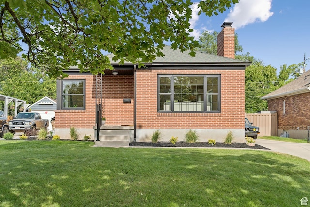 2487 S Beverly St E, Salt Lake City, UT 84106 - view of front of house featuring a chimney, brick siding, and a front lawn
