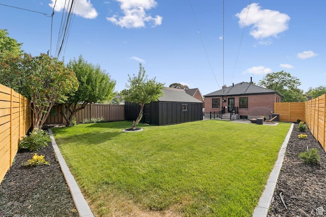 2487 S Beverly St E, Salt Lake City, UT 84106 - fenced backyard featuring an outbuilding, an outdoor living space, and a patio