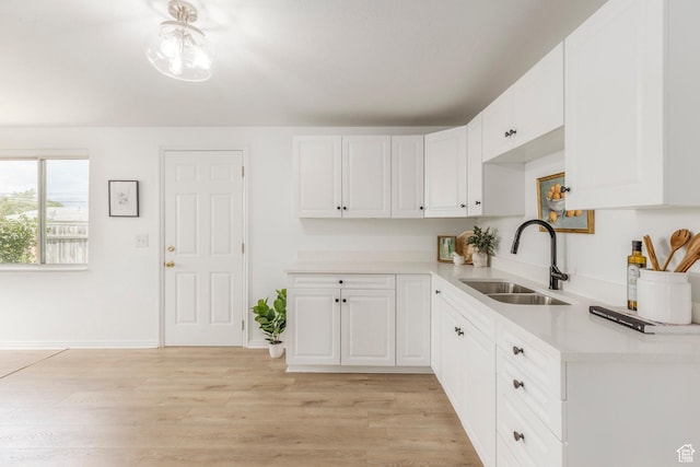 5655 S 700 W, Murray, UT 84123 - kitchen featuring light countertops, white cabinets, and light wood-style floors