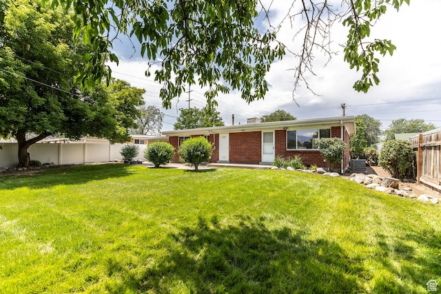 5655 S 700 W, Murray, UT 84123 - view of front of house with brick siding and a fenced backyard