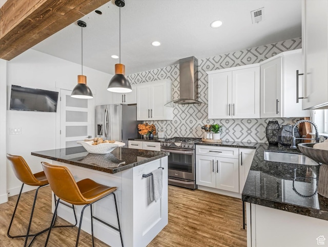 14735 S Asher Ln W, Bluffdale, UT 84065 - kitchen featuring wall chimney range hood, stainless steel appliances, white cabinets, light wood-style flooring, and recessed lighting