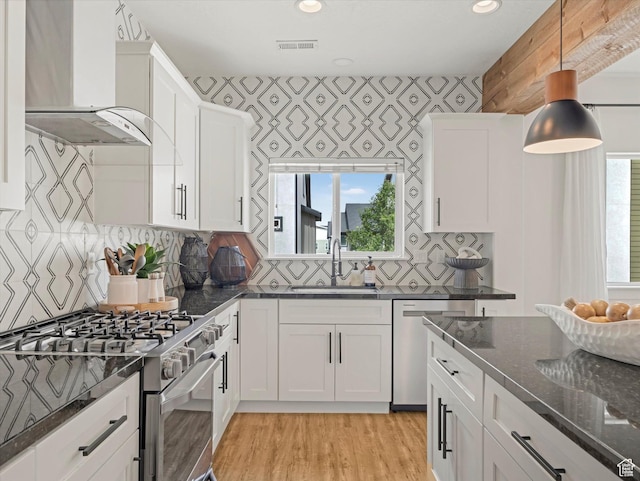 14735 S Asher Ln W, Bluffdale, UT 84065 - kitchen with appliances with stainless steel finishes, extractor fan, light wood-style flooring, dark stone countertops, and white cabinetry