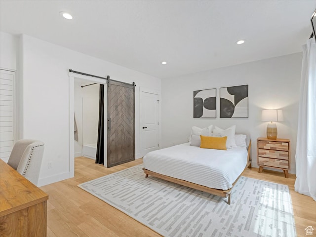 14735 S Asher Ln W, Bluffdale, UT 84065 - bedroom with a barn door, light wood-type flooring, and recessed lighting