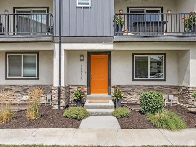 14735 S Asher Ln W, Bluffdale, UT 84065 - entrance to property with a balcony, stone siding, and stucco siding