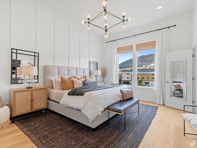 14735 S Asher Ln W, Bluffdale, UT 84065 - bedroom featuring light wood-style flooring, a chandelier, and a mountain view