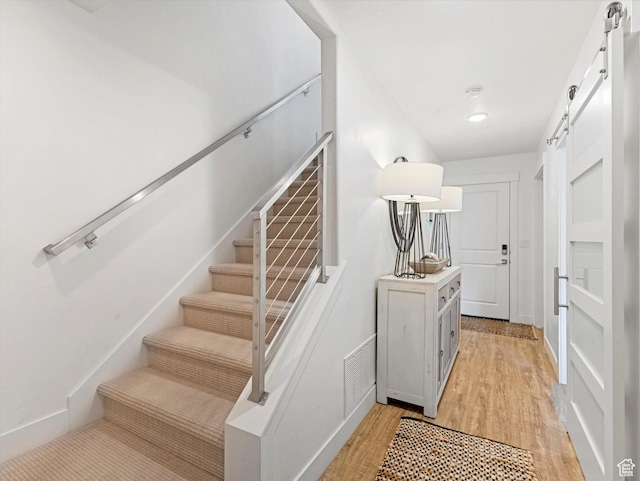 14735 S Asher Ln W, Bluffdale, UT 84065 - staircase with a barn door and wood finished floors