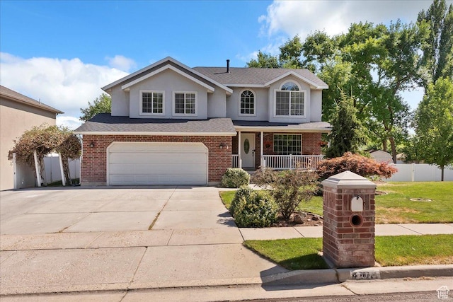 707 W 3675 S, Riverdale, UT 84405 - traditional-style house featuring a porch, driveway, brick siding, a garage, and stucco siding