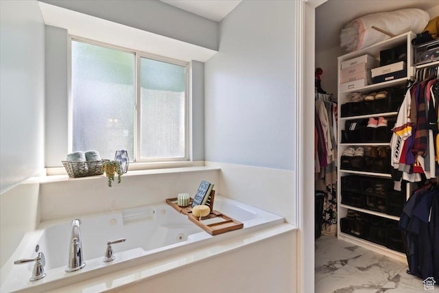 707 W 3675 S, Riverdale, UT 84405 - bathroom featuring marble look tiles, a tub with jets, and a spacious closet