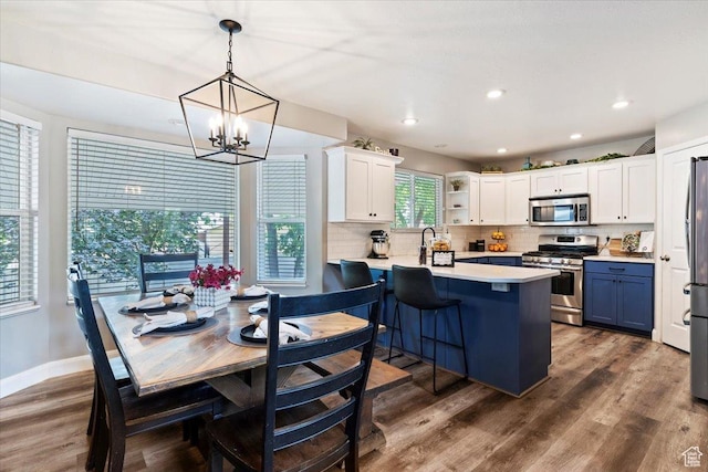 707 W 3675 S, Riverdale, UT 84405 - kitchen featuring appliances with stainless steel finishes, a chandelier, light countertops, tasteful backsplash, and white cabinets