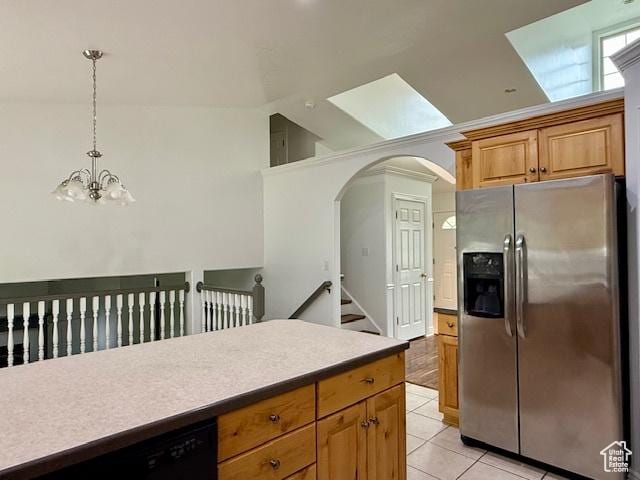 943 W Majestic, Logan, UT 84321 - kitchen with stainless steel fridge with ice dispenser, lofted ceiling, arched walkways, dishwasher, and light tile patterned floors