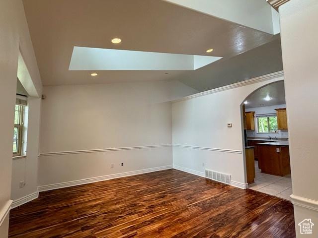 943 W Majestic, Logan, UT 84321 - unfurnished room with light wood-type flooring, arched walkways, a skylight, and recessed lighting