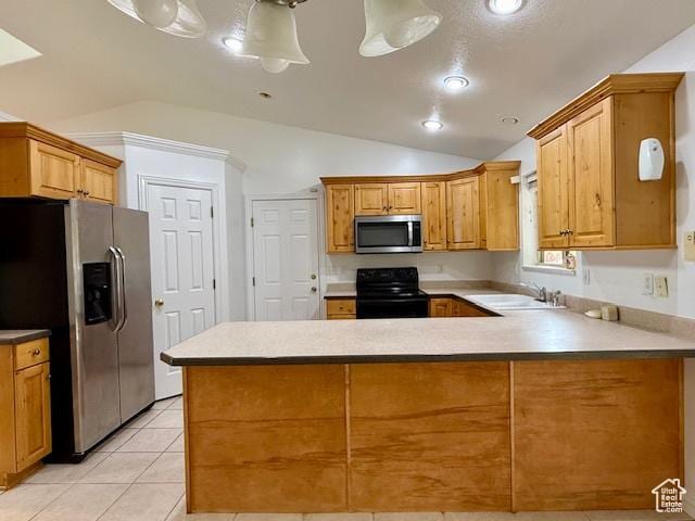 943 W Majestic, Logan, UT 84321 - kitchen with appliances with stainless steel finishes, lofted ceiling, a peninsula, light tile patterned floors, and light countertops
