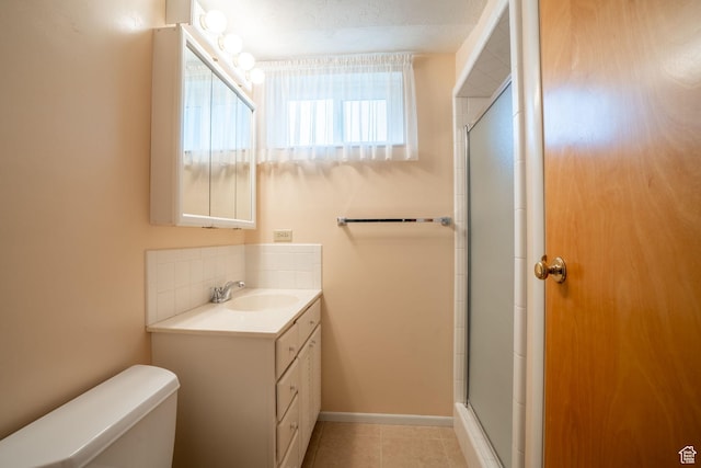 1083 W 10550 S, South Jordan, UT 84095 - bathroom featuring vanity, a shower with shower door, backsplash, and tile patterned flooring
