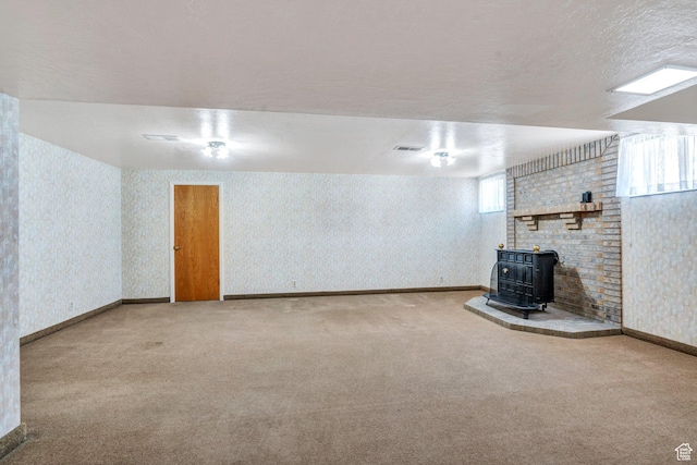 1083 W 10550 S, South Jordan, UT 84095 - basement featuring a wood stove, carpet floors, wallpapered walls, and a textured ceiling