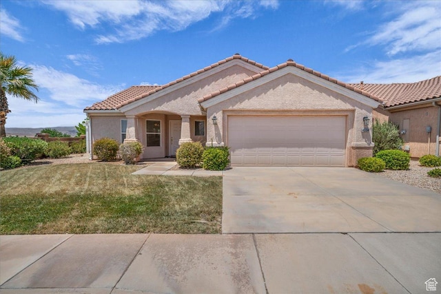 4534 S Big River Dr, St George, UT 84790 - view of front facade featuring an attached garage, a tiled roof, concrete driveway, a front lawn, and stucco siding